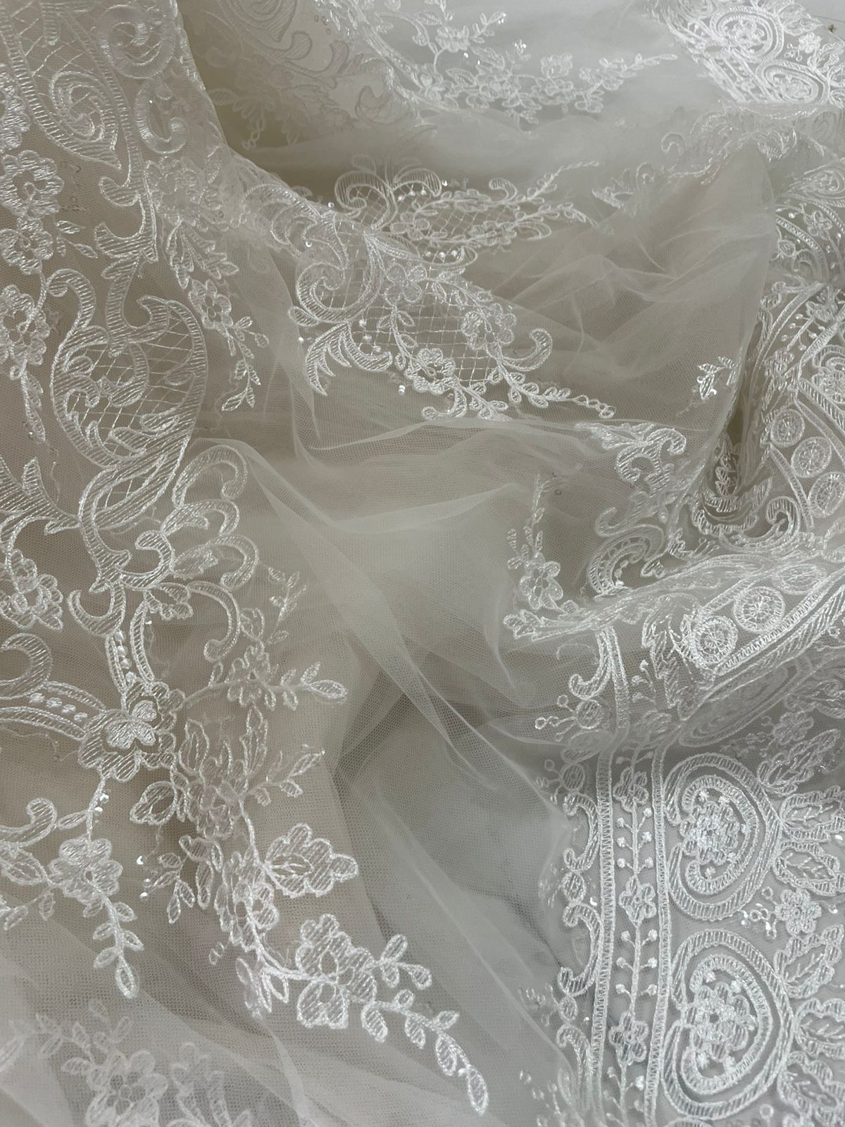 Final QC lace detail for Franziska's premium Alencon lace mermaid dress showing transparent tulle and Alencon layering