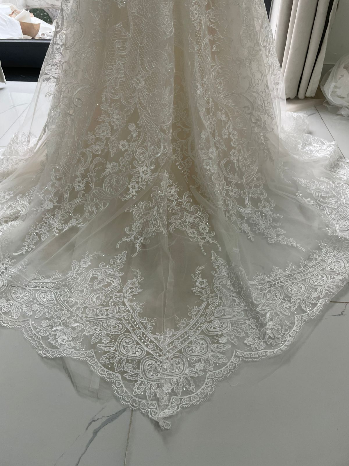 QC train detail for Franziska's premium Alencon lace mermaid wedding dress showing train spread and lace finish