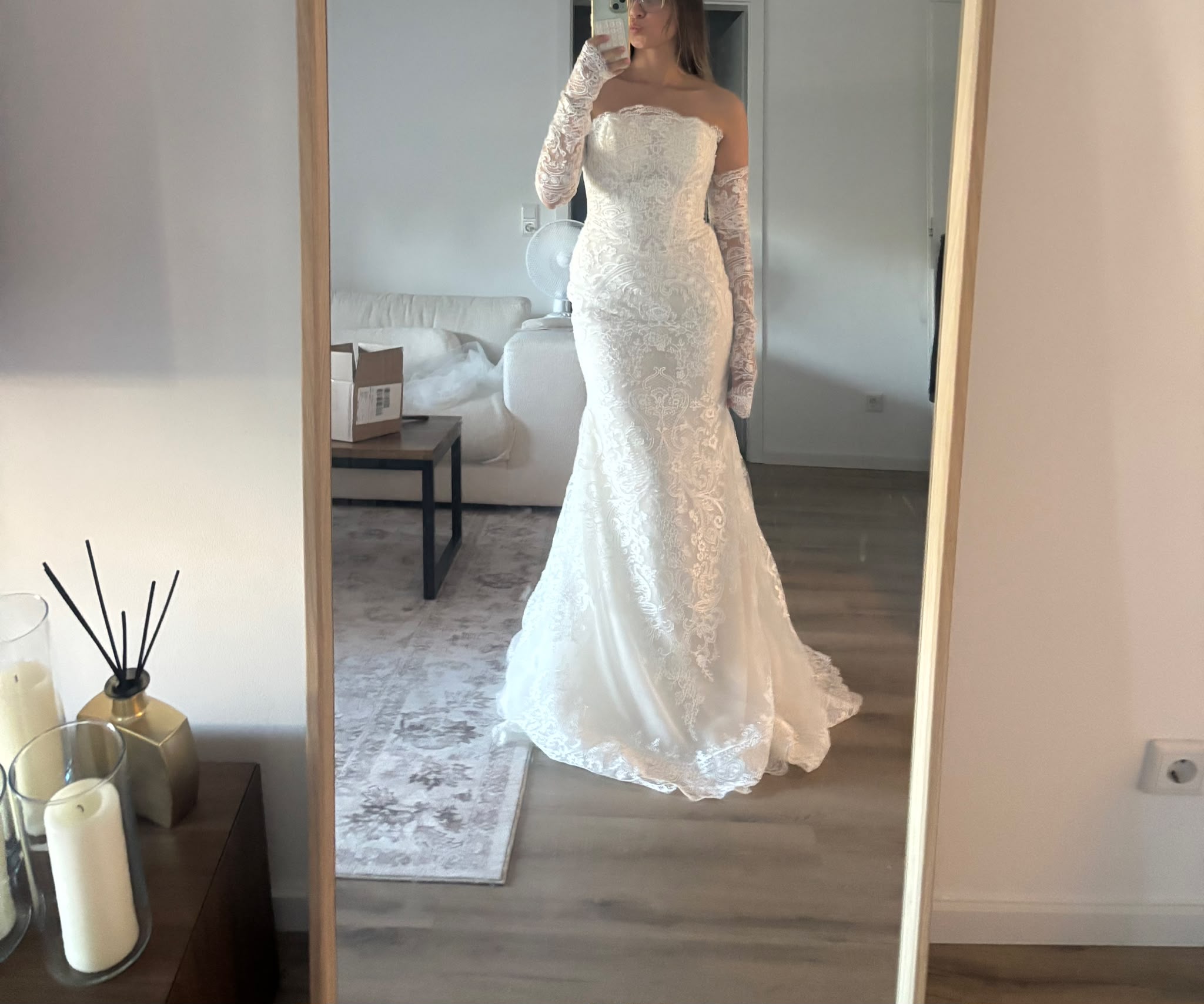Franziska trying on her Alencon lace mermaid wedding dress after delivery in Germany, showing cup fit and silhouette